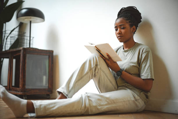 istock young woman reading a book 1845642031