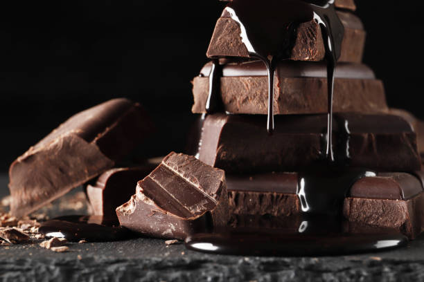 istock melted chocolate pouring into a piece of chocolate bars   on a dark  table 1845649349