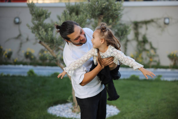 istock Happy little girl playing outside with her dad 1845649949