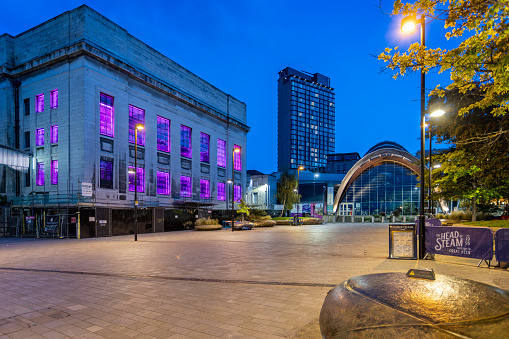 Winter gardens and the Central Library lit up at night in Tudor Square, Sheffield, South Yorkshire, UK on 25 July 2023
