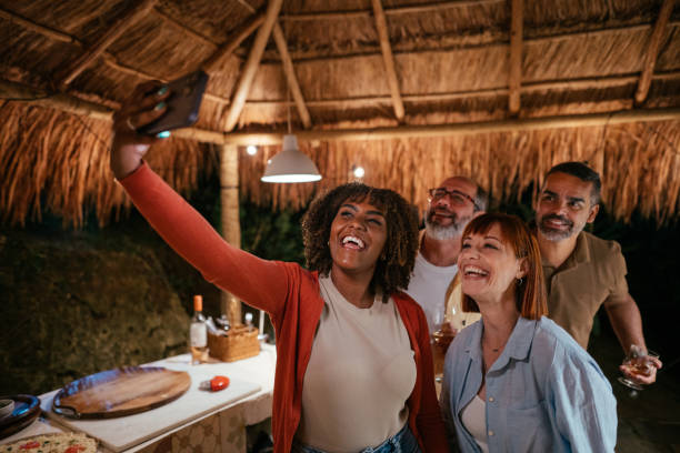 istock Laughing friends taking selfies during a dinner party on a patio 1845679539
