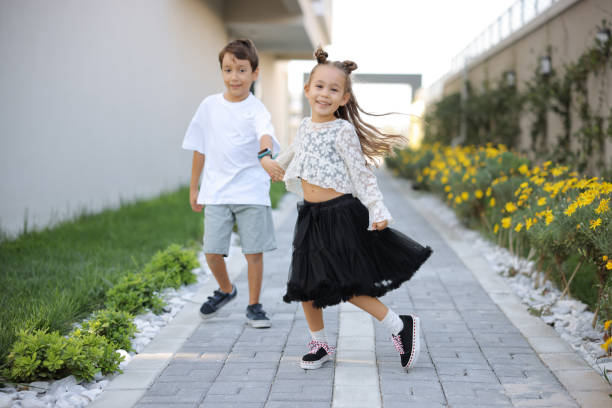 Happy, black kids running in garden and play game together outdoor at home. Children in backyard, excited and race or funny sister chase brother, bonding and laughing for freedom or energy