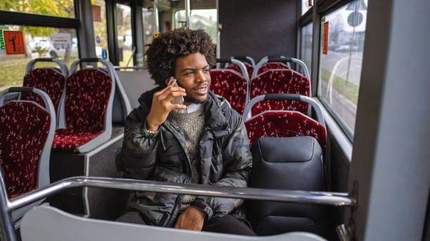 istock While commuting with a bus, young man Black ethnicity talking on mobile phone 1845726341