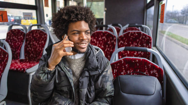 istock While commuting with a bus, young man Black ethnicity talking on mobile phone 1845727398