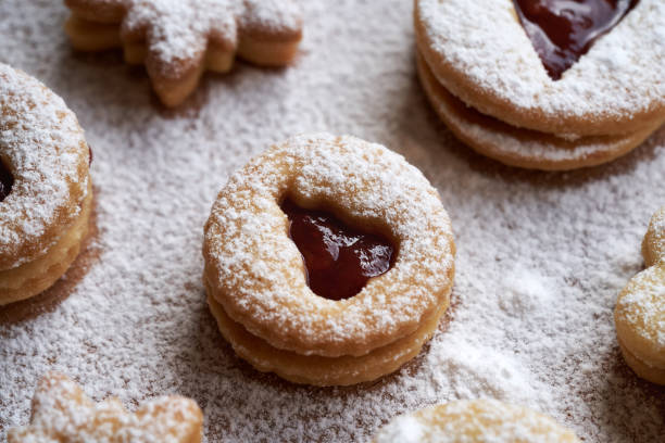 Round Linzer Christmas cookie filled with strawberry jam and dusted with sugar