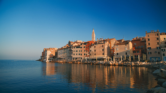 Captivating Rovinj,The picturesque old town nestled by the sea,framed against a clear blue sky in Croatia. A timeless scene of coastal beauty,inviting awe and appreciation for the charm of this Croatian gem
