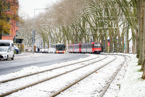 Cologne, Germany December 04 2023: tram, bus and car traffic after snowfall at melatengürtel in cologne ehrenfeld