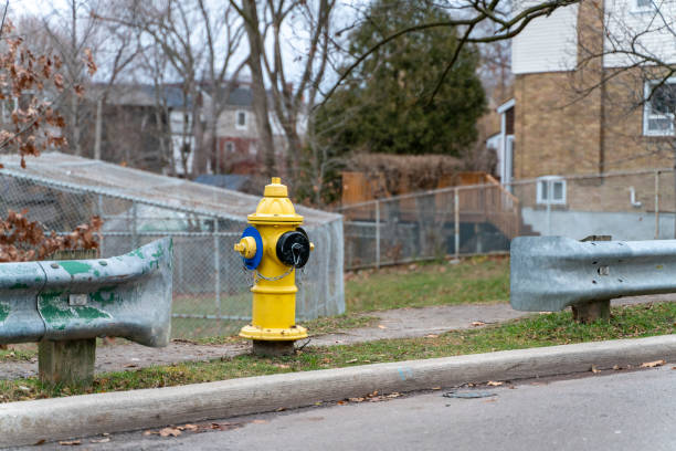 istock Yellow Fire Hydrant in Residential Area in-between Road Barricade 1845844872