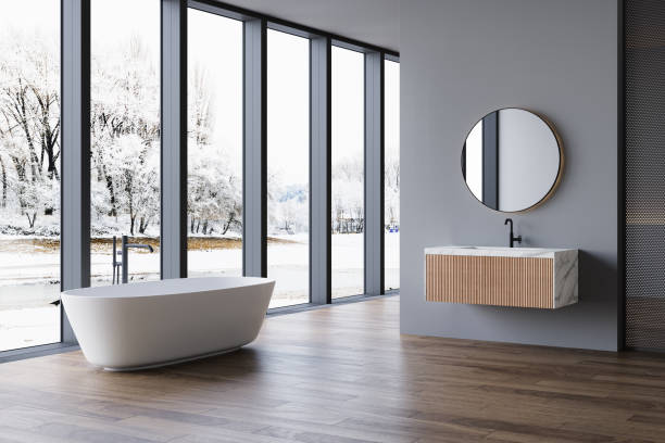 istock Modern bathroom interior with winter concept, white bathtub and chic vanity, black walls, parquet floor, plants, natural lighting. Minimal bathroom with modern furniture 1845857742
