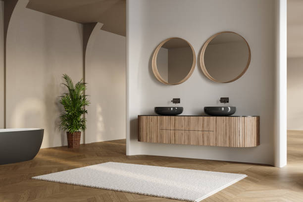 istock Modern bathroom interior with dark brown parquet floor, two sinks, double mirrors, white bathtub, interior plants, front view. Minimalist bathroom with modern furniture and arches. 1845868046