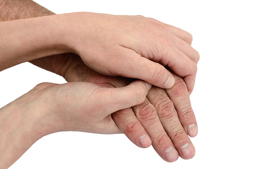 Hands of young woman hold hands of an old man