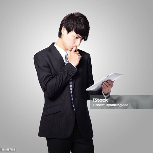 Business Man Reading News On Tablet Pad Stock Photo - Download Image Now - Adult, Asian and Indian Ethnicities, Business