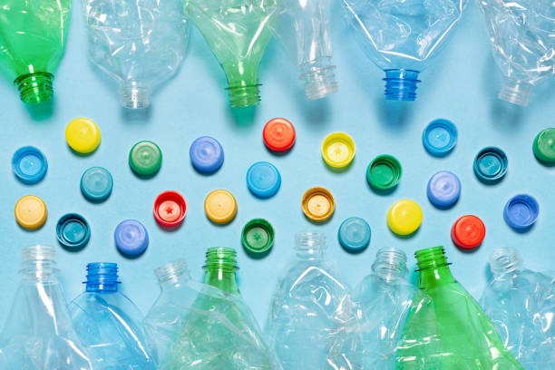 istock Crushed plastic bottle recycling plastic cap separate bottle lids. Separate waste sorting and recycling PET bottle cap recycling materials. Used PET plastic sorting. Flat lay design 1845875250