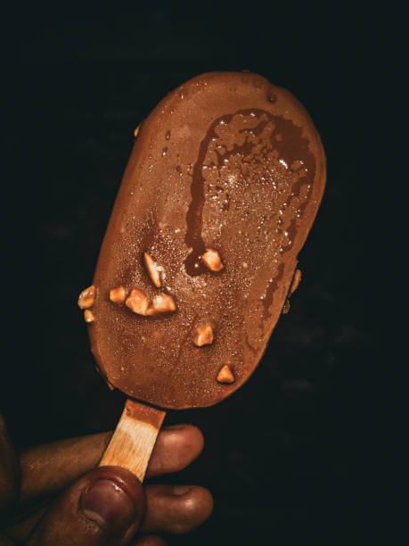 istock “Hand Holding a Chocolate Ice Cream Bar”. 1845895412
