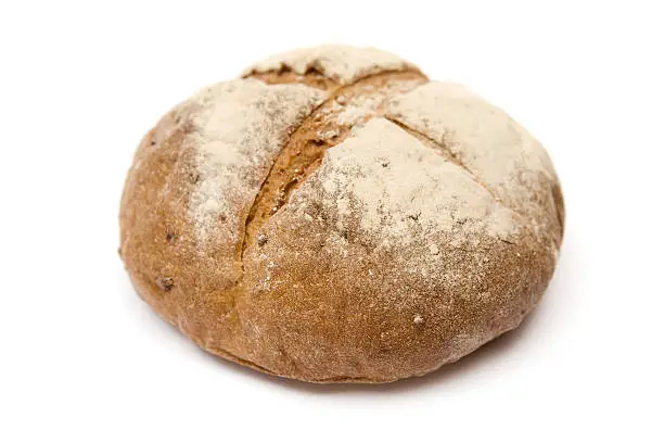 Loaf of brown bread isolated on a white background.