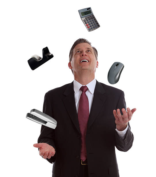 istock Businessman Juggling Office Supplies 184591707