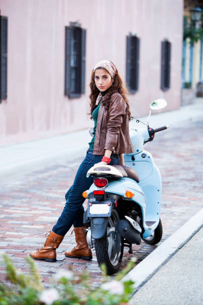 istock Young woman leaning on motor scooter 184591817