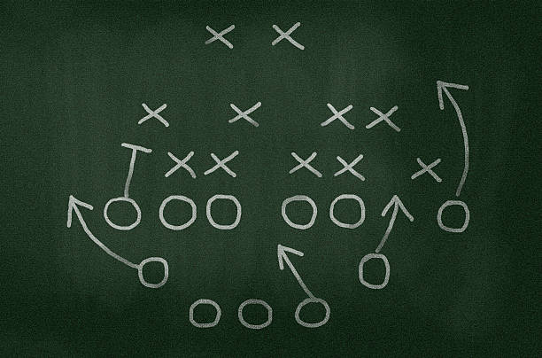 American football strategy diagram on chalkboard, vignette added American football strategy diagram on chalkboard, slight vignette added. american football game plan stock pictures, royalty-free photos & images