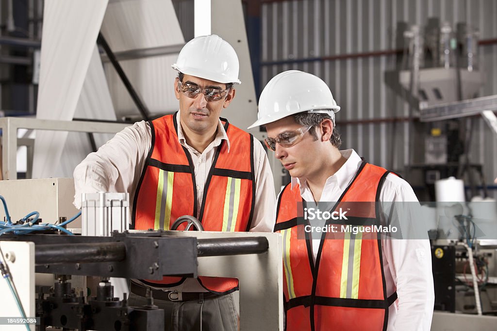 Engineers in Outsourcing Printing Industry Couple of Engineers in Bagging Printing Line Accuracy Stock Photo