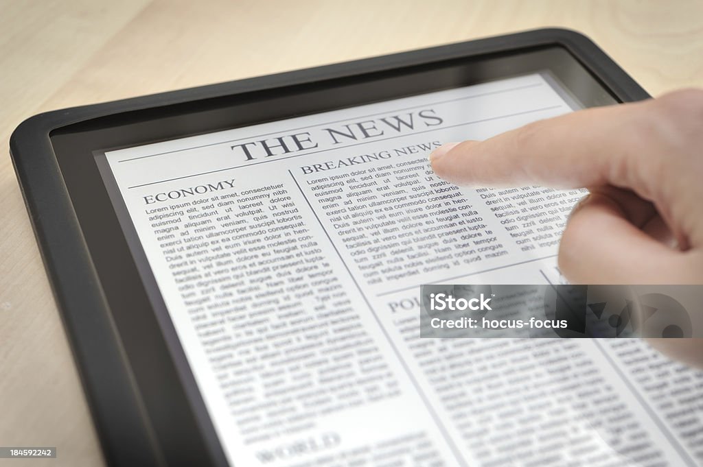 Reading news with digital tablet Hand touching digital tablet displaying news. Digital Tablet Stock Photo