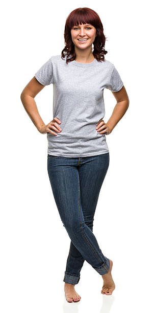 Smiling Young Woman Standing With Legs Crossed