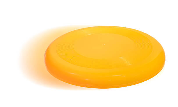 Isolated image of a yellow Frisbee An ordinary yellow frisbee, isolated on white. plastic disc stock pictures, royalty-free photos & images