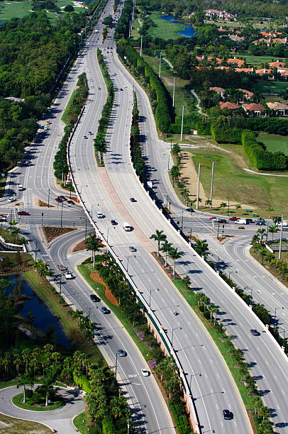 Road Corridor and Overpass A newly constructed road with overpass.  Taken from a helicopter at 500 feet. collier county stock pictures, royalty-free photos & images