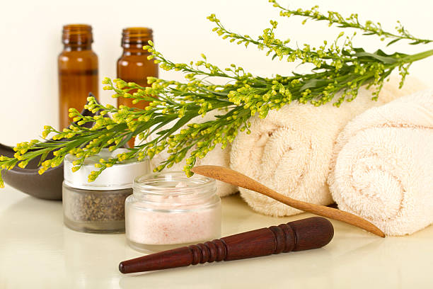 Spa products and tools with selective focus on the wooden stick that is used for foot massage (studio shot).Further choices below: