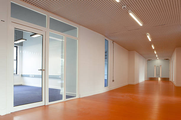 Empty office space featuring a laminate wood floor corridor stock photo