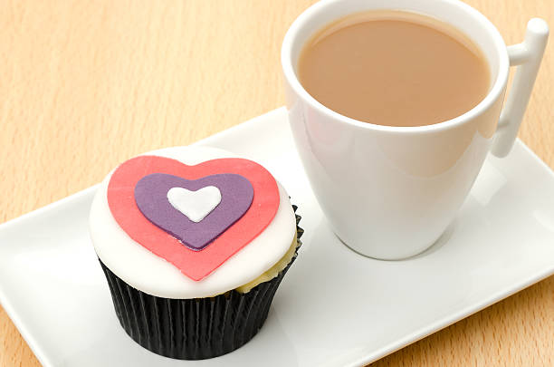 istock Iced cupcake with a cup of tea 184594957