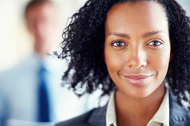 istock Smiling woman with a man blurred in the background 184595547