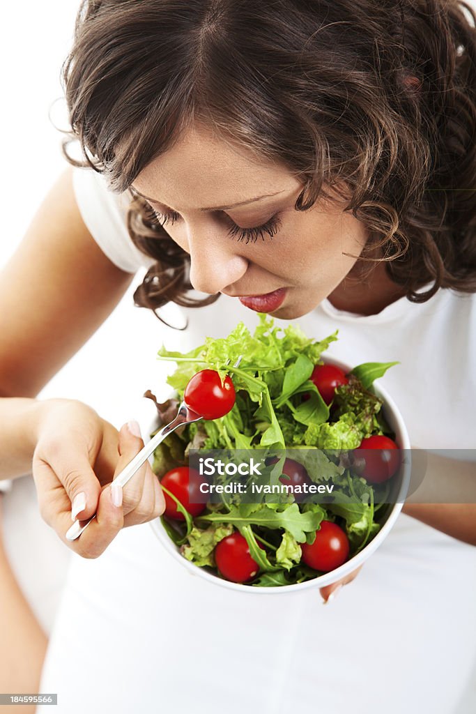 Здоровая молодая женщина готовит салат - Стоковые фото Белый фон роялти-фри