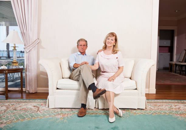 istock Senior couple sitting on couch 184595647