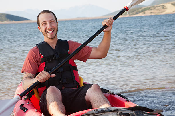 istock Happy young kayaker on a lake in his kayak 184595833