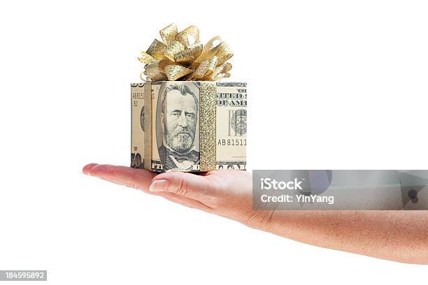 Hand Offering Gift Of Money In Gold Ribbon On White Stock Photo - Download Image Now