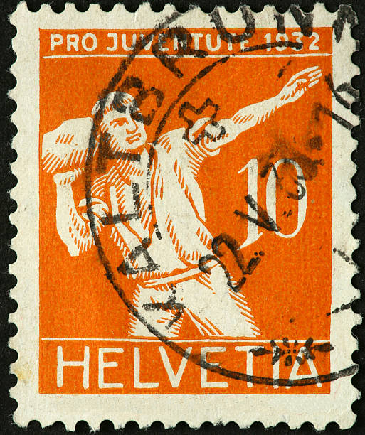 istock man throwing a large rock on an old Swiss stamp 184596336