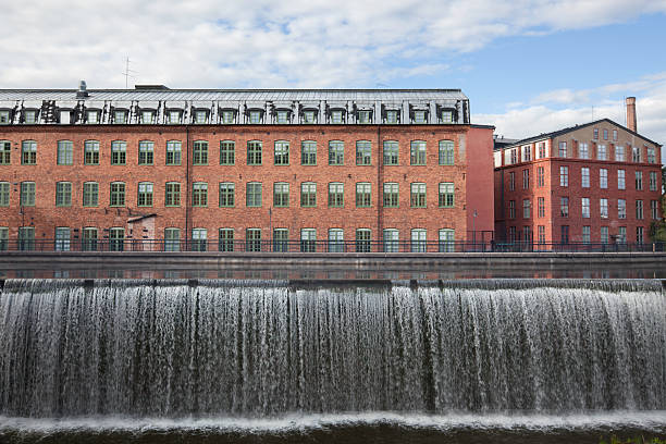 Industrial buildings "Industrial buildings and waterfall in central NorrkAping, Sweden." ostergotland stock pictures, royalty-free photos & images