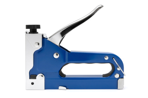 Blue staple gun isolated on a white background.