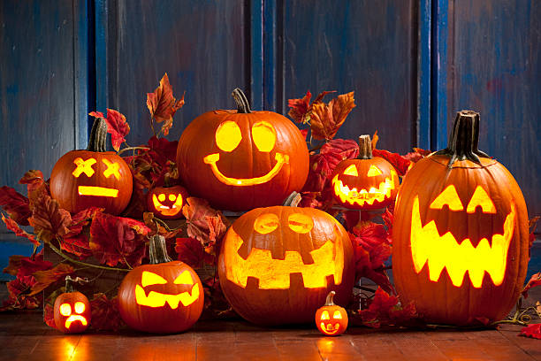 Halloween Jack-o-Lantern Pumpkins A group of Jack-o-lanterns lit up for the holiday.Click here To View My Halloween Lightbox halloween pumpkin decorations stock pictures, royalty-free photos & images