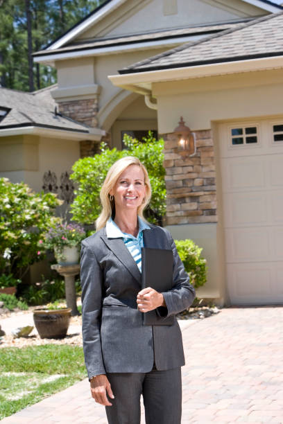 istock Professional agent in business suit standing outside house 184597178