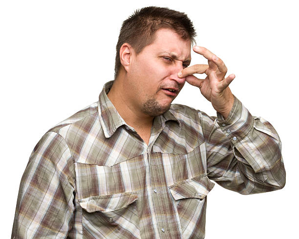 Man Pinching Nose Portrait of a man on a white background. http://s3.amazonaws.com/drbimages/m/jr.jpg holding nose stock pictures, royalty-free photos & images
