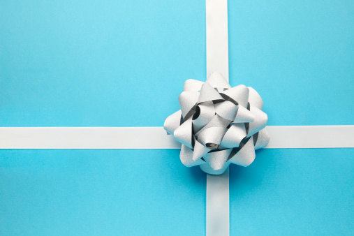 A silver bow on a blue striped background.