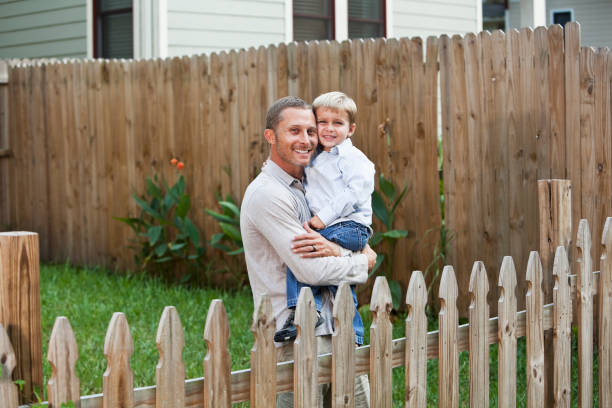 istock Father holding little boy in backyard 184597518