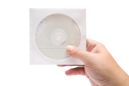 Man holding a wrapped CD. Isolated on a white background.
