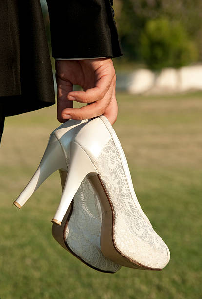 groom with wedding shoes