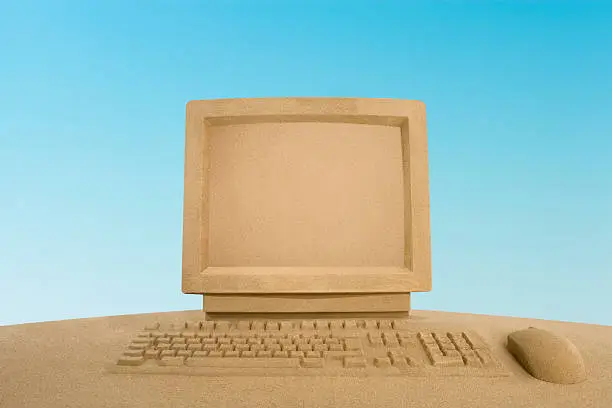Sand sculptured computer, keyboard and mouse. 