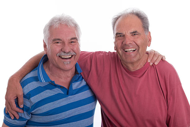 istock Two happy laughing senior men embracing 184598506