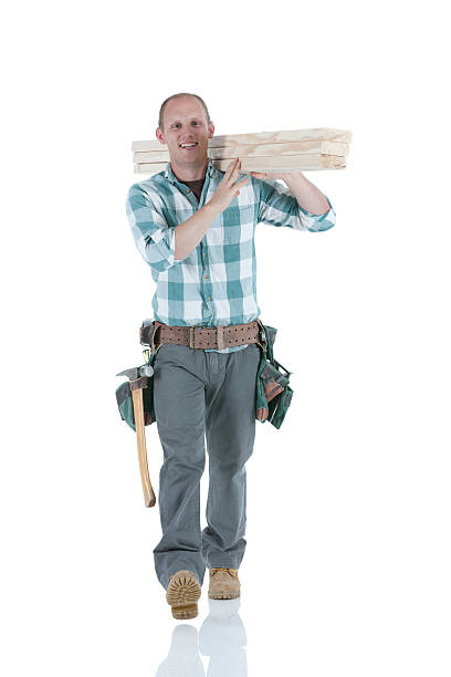 istock Carpenter carrying wooden planks 184598870