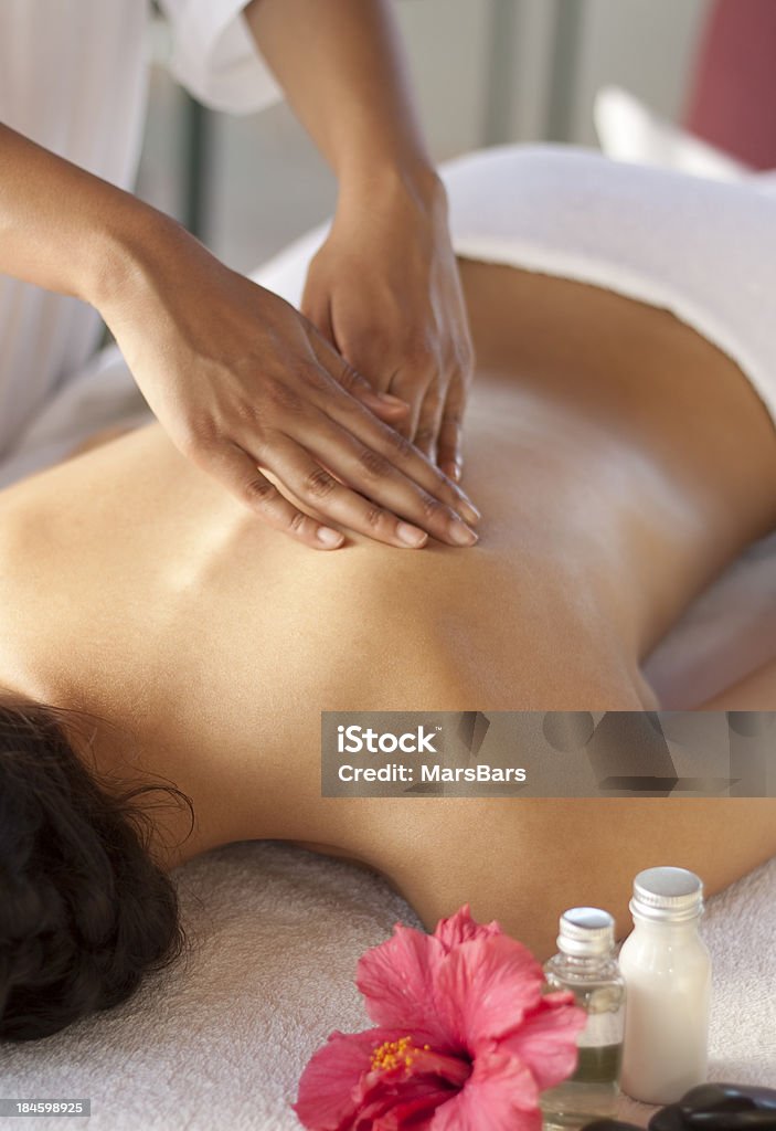 Back massage at the spa Masseuse giving a relaxing back massage at a spa. You may also like: Massaging Stock Photo