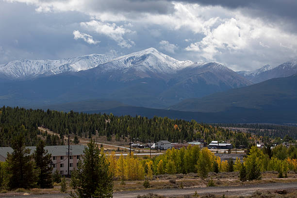 Storm over Leadville and Mount Elbert Colorado Sawatch Mountains "Storm clouds blow by the historic gold and silver mining town of Leadville with Mount Elbert in the distance at 14433 feet, the highest mountain in Colorado and the Sawatch Mountain range. Beautiful gold aspen trees light the foreground." leadville stock pictures, royalty-free photos & images